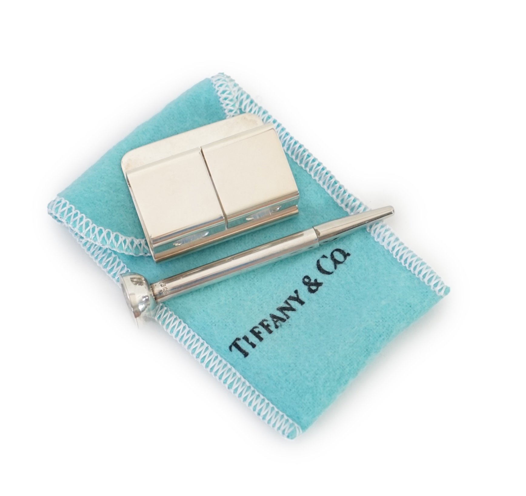 A Tiffany & Co. golf tee holder and pencil